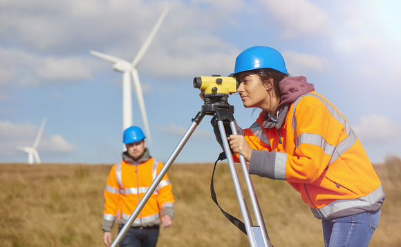 An onshore wind technician assess the turbine An onshore wind technician assess the turbine